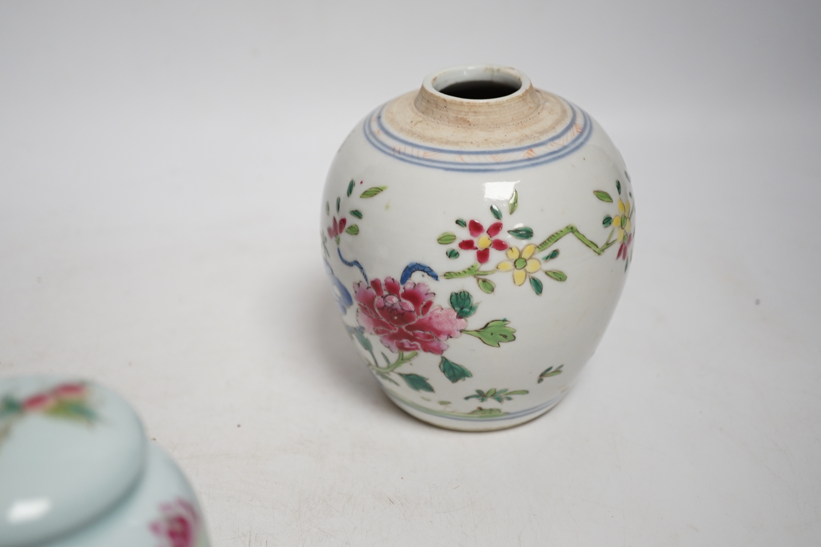 A collection of Chinese ceramics including celadon bowl decorated in low relief with fish, famille rose tea bowls and a jar, largest 12cm high